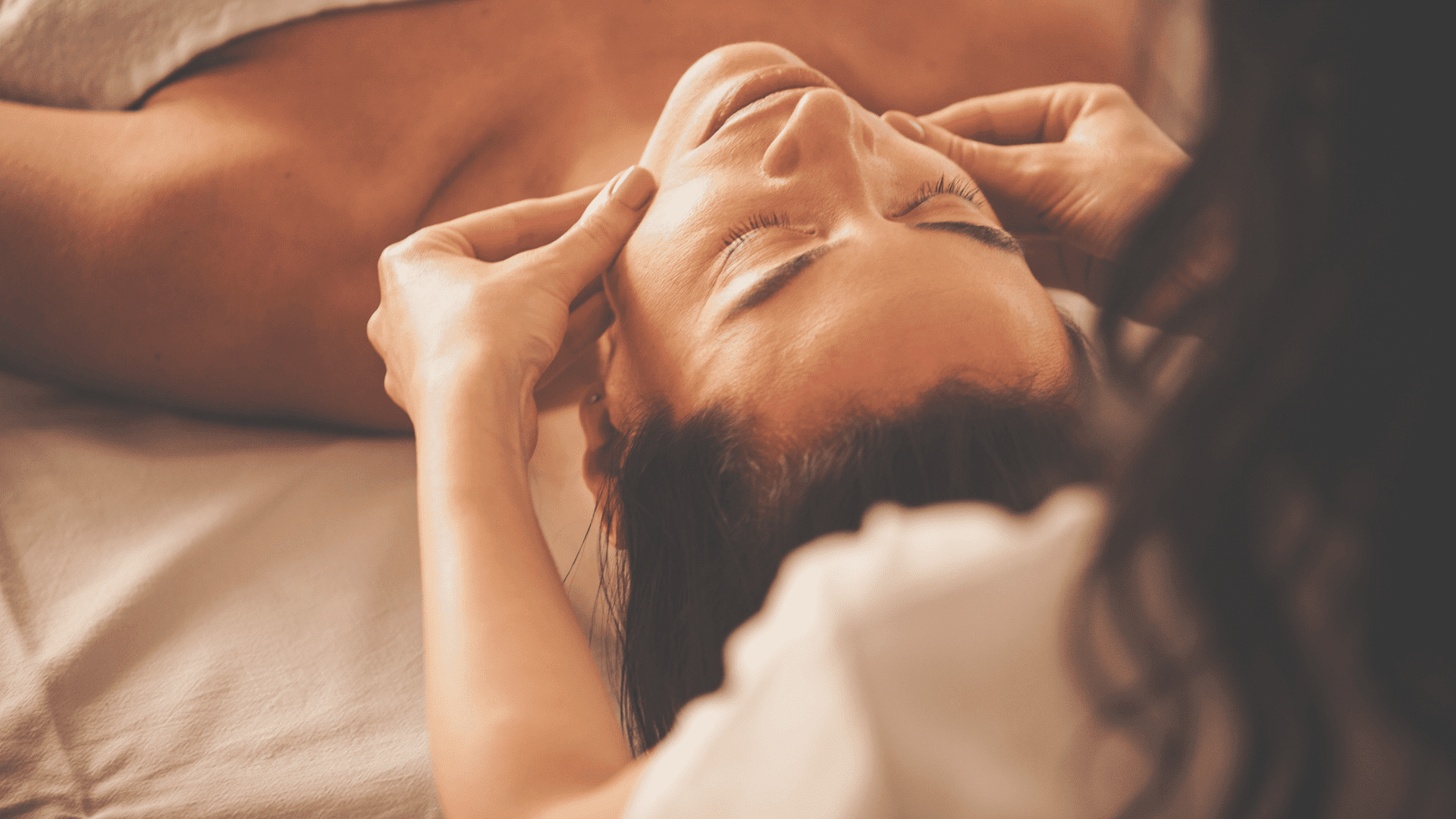 Person receiving a relaxing facial massage at a spa.